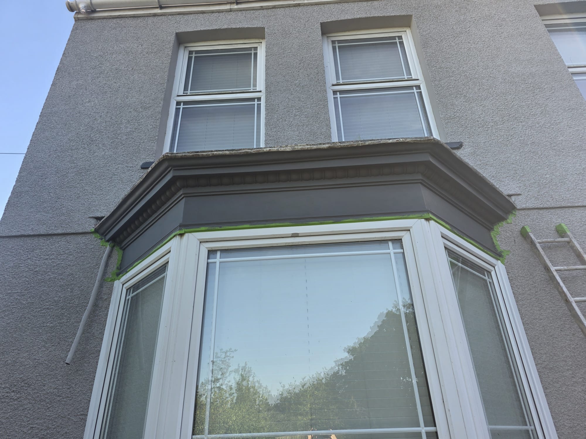 Completed grey trim against light render — South Wales exterior painting