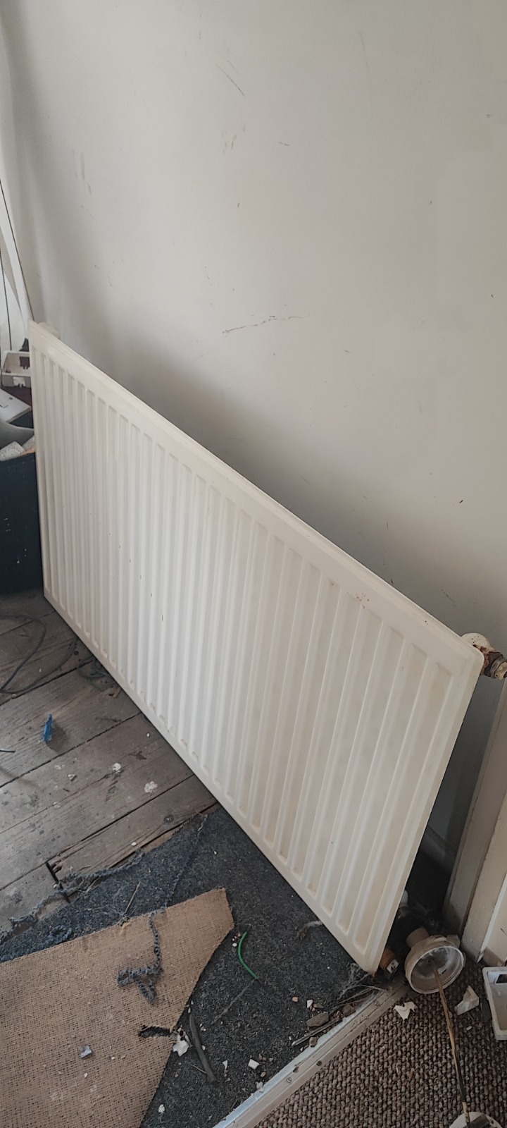 Radiator removed and floor prepped for new boards — Cwmbran maintenance