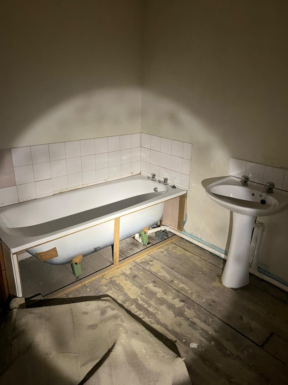 New bath levelled into position during bathroom refurbishment — Cwmbran