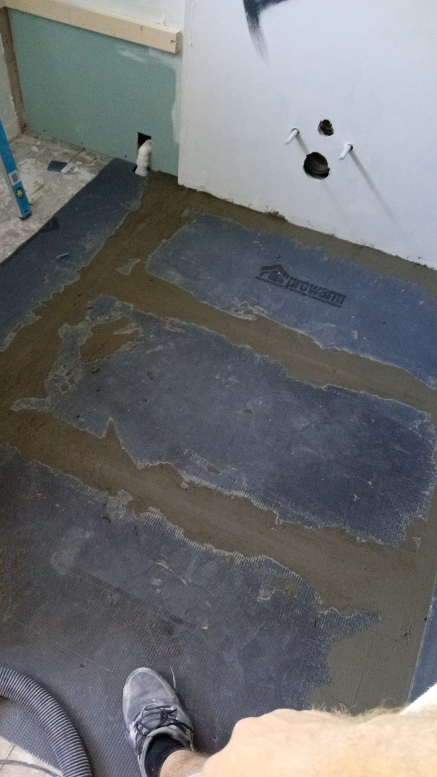 Underfloor heating mat being laid in a new bathroom — Cwmbran install