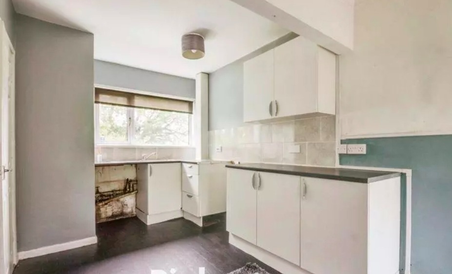 Finished white kitchen with new units and worktop — South Wales refurbishment