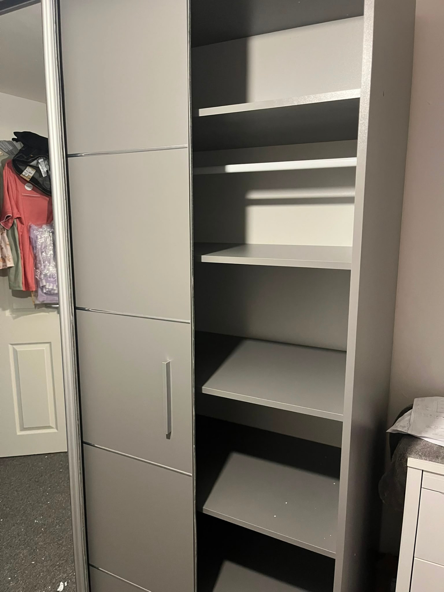 Interior of newly assembled wardrobe with hanging rail and shelving — South Wales