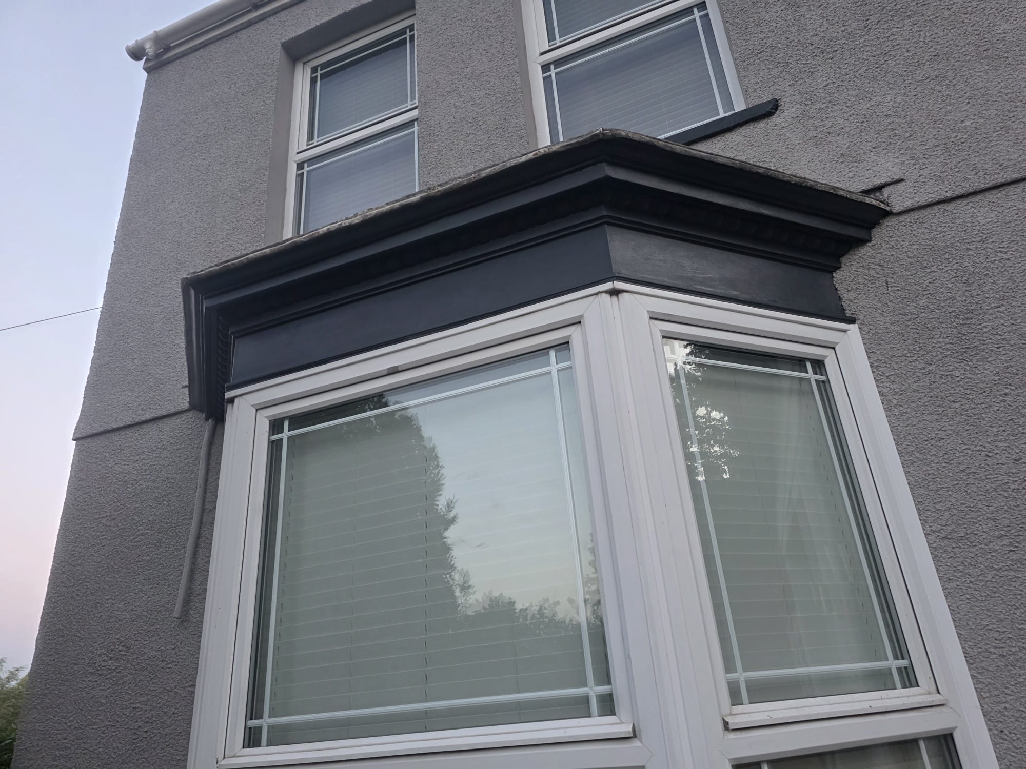 Bay window repainted in dark grey — Newport exterior painting