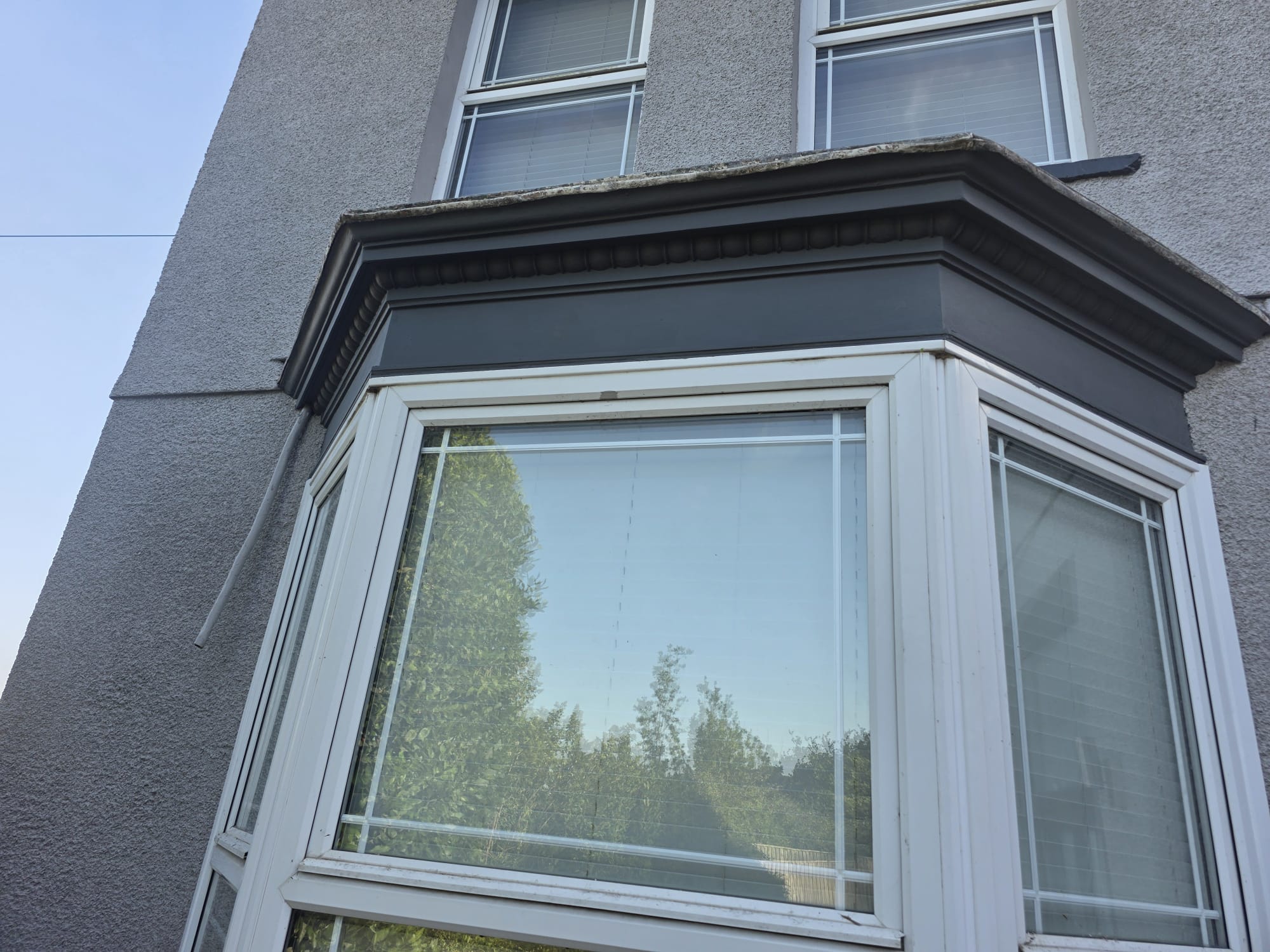 Finished dark grey window trim after full repaint — South Wales